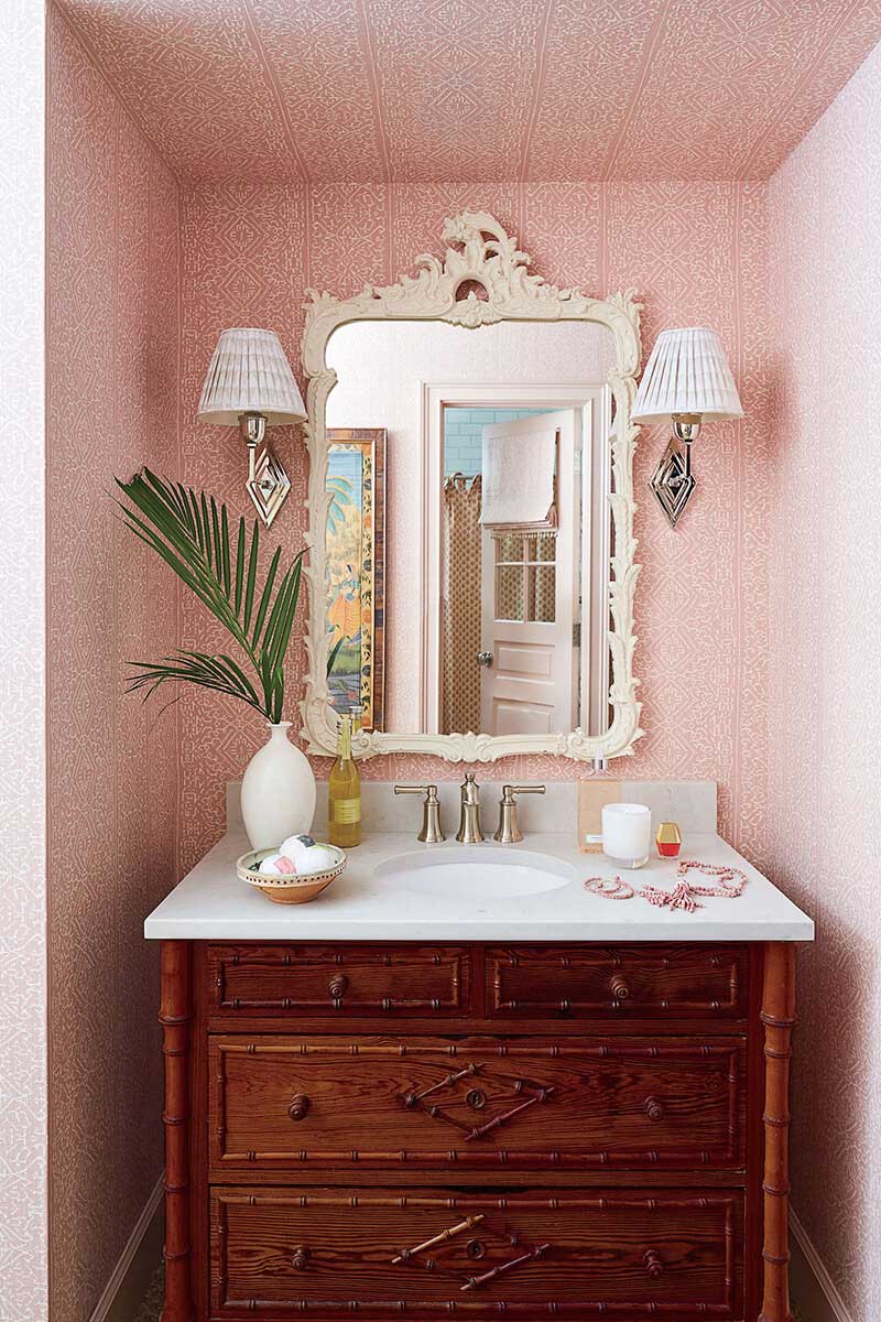 Girls bathroom with wallpaper and mirror and vanity