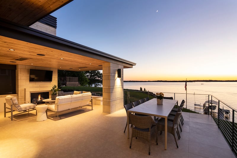  A home’s outdoor dining space and entertainment center overlooking Lake Minnetonka.