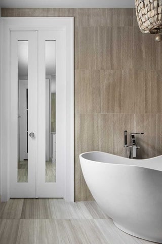 Mirrored TruStile Bi-Fold doors in a modern bathroom with large white bathtub.