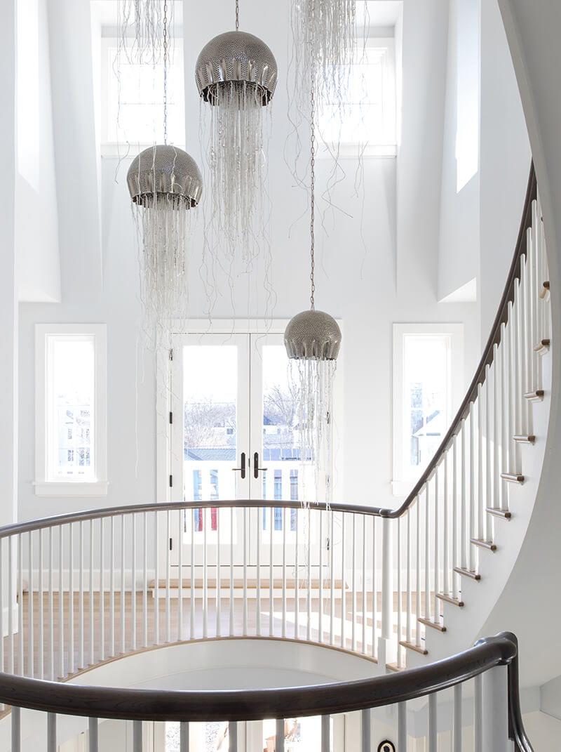 Elliptical staircase in the entry of a Fairfield, Connecticut home.