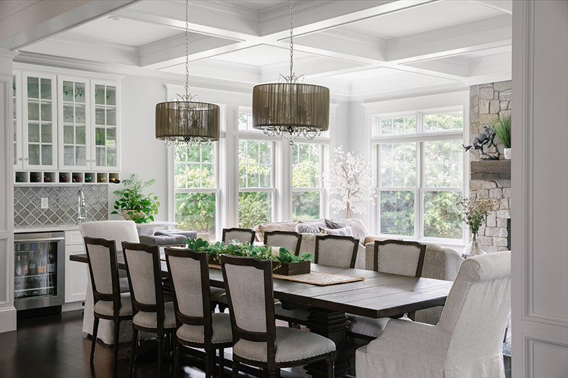 The dining room in a contemporary cottage home, featuring Marvin Elevate double hung windows.