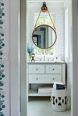 Bathroom with white cabinet and small mirror