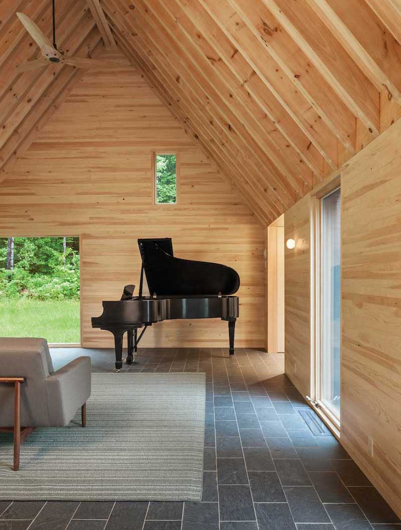 Interior photo of Marlboro Music Cottages, featuring Marvin Ultimate Casement windows and Ultimate Picture windows beside a black grand piano.