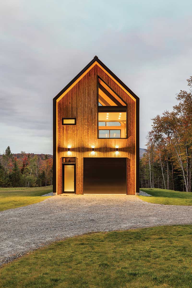 The exterior of a modern home in Vermont, featuring Marvin windows and doors in unique shapes.