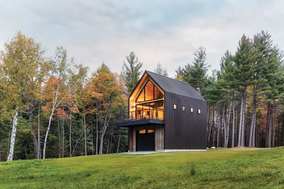 The exterior of a modern guest house and garage in Vermont, featuring Marvin windows and doors.