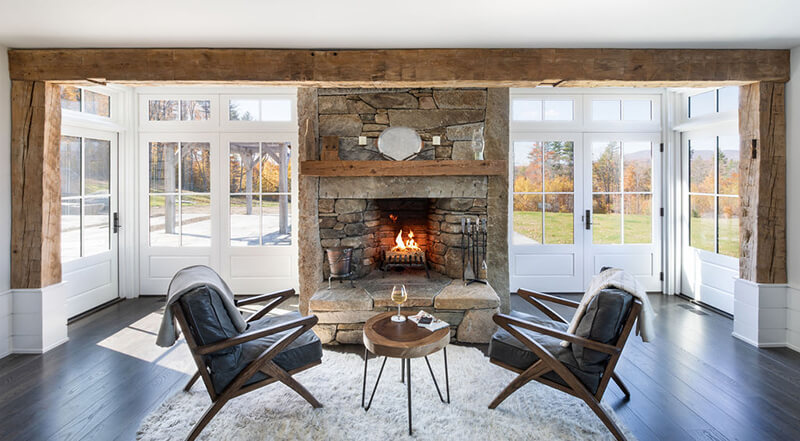 A cozy spot filled with light near a fireplace inside The Middletown Ridge House.