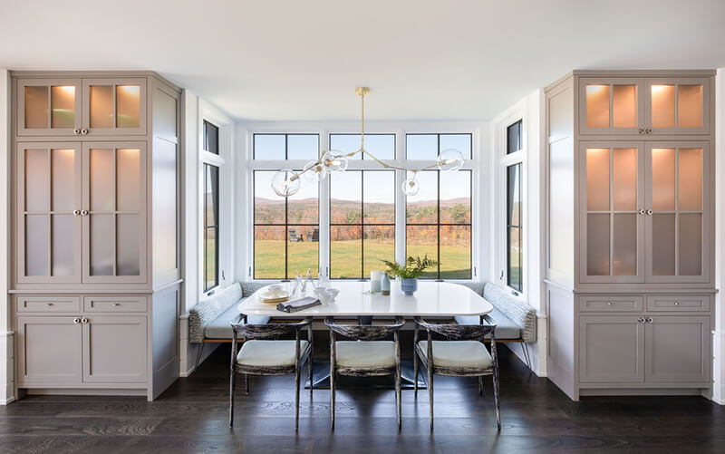 A dining area with Marvin windows in the kitchen of The Middletown Ridge House.