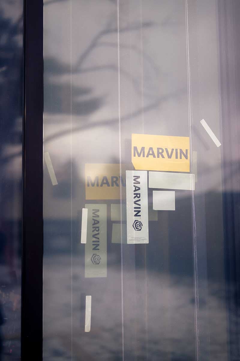 A Marvin Modern window with yellow Marvin sticker on a job site.