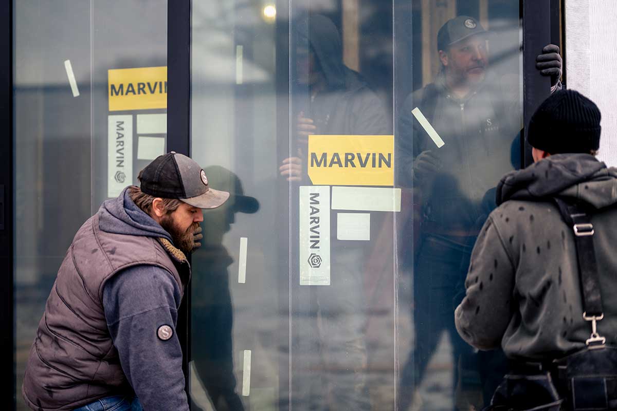 Two men installing Marvin Modern windows.