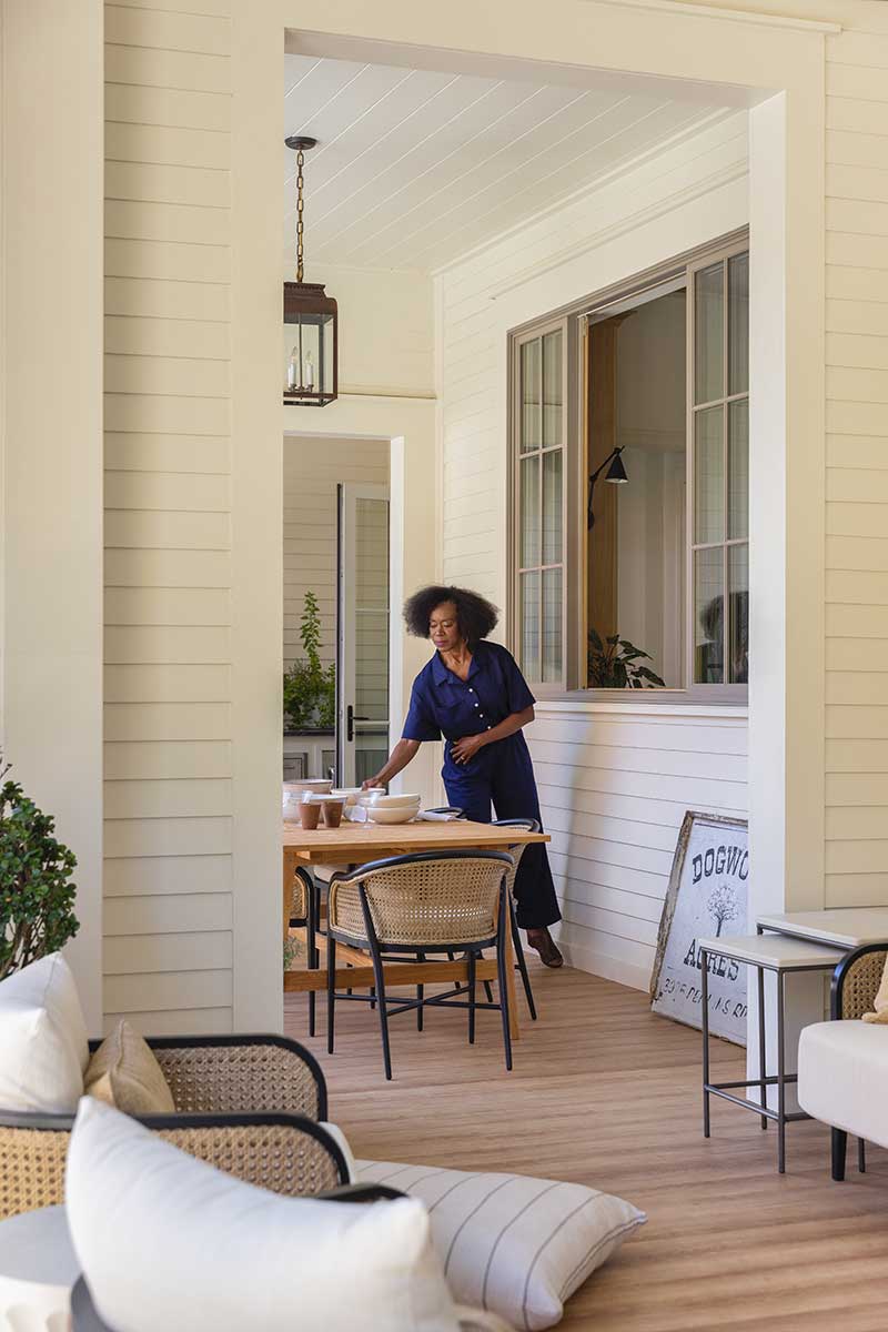 Woman on porch with Marvin Elevate Sliding French Door