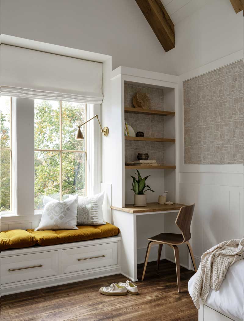 A window seat and built-in desk in a bedroom of the Southern Living Idea House, featuring Marvin windows.