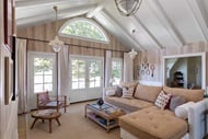 Living room with Marvin Signature Ultimate Round Top window and Inswing French Door