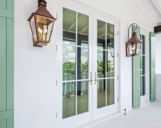 The exterior of a white home with Coastline Outswing french doors