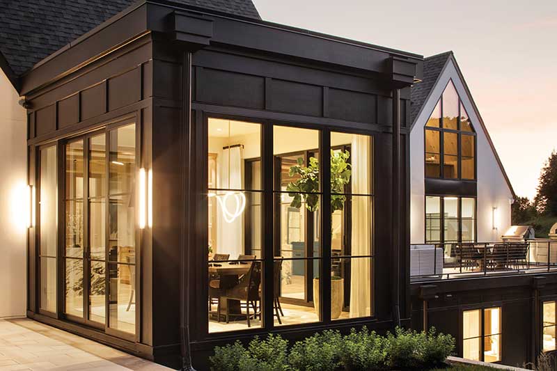 The exterior of a home featuring black Marvin Modern Multi-Slide Door and Marvin Modern Direct Glaze windows on a Modern dining room.