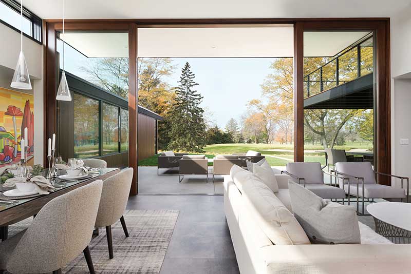 A dining room featuring a Marvin Ultimate Lift and Slide door opening up to a patio.