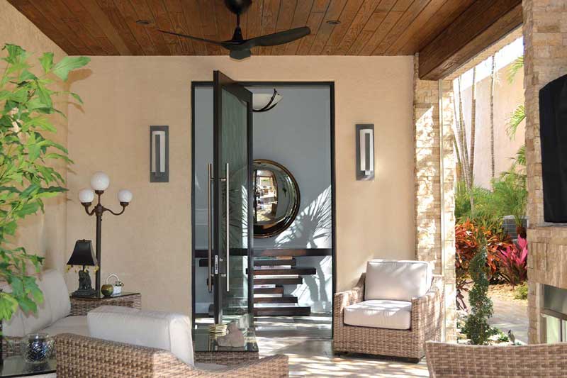 A covered porch featuring a Marvin Coastline Outswing Pivot door.