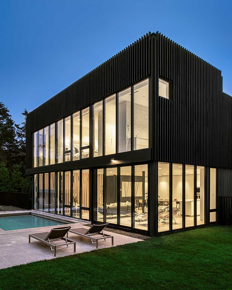 Marvin Modern Casement, Direct Glaze, and Awning windows aglow at night in a modern home in Sag Harbor, New York. 
