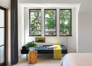 A bedroom with three casement windows.