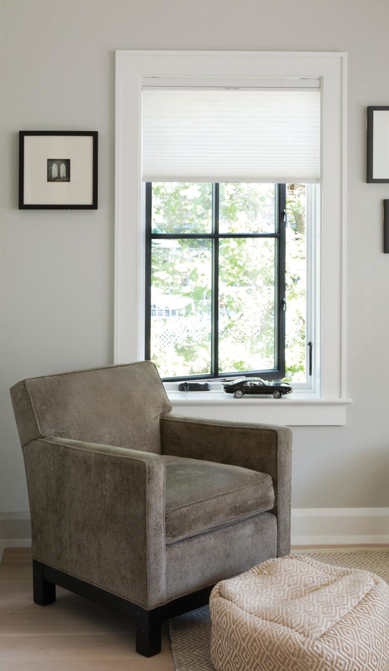 An open casement window next to a chair.