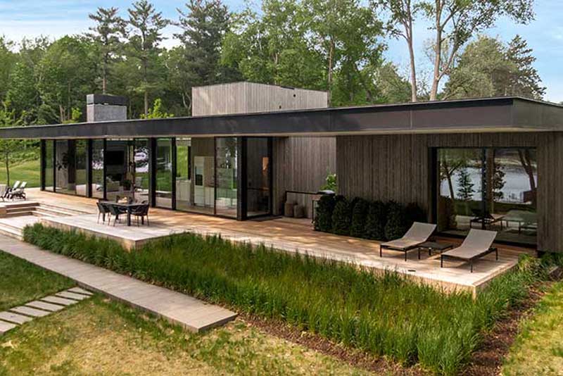 The back patio of a modern home on Lake Minnetonka with Marvin Modern Multi Slide Doors and Marvin Modern Direct Glaze windows.