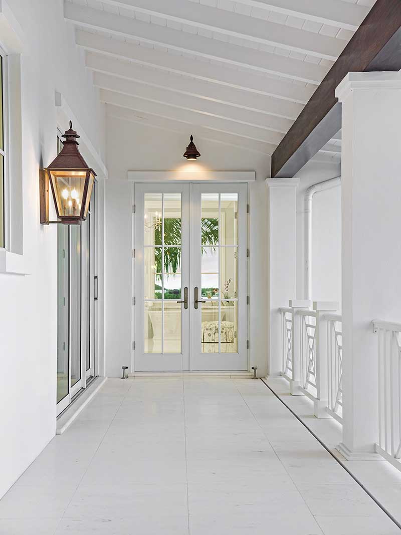 A white Marvin Coastline Outswing French door on a balcony.