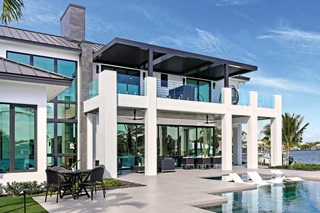 The exterior of a home in coastal Florida, featuring Marvin Coastline windows and doors made of extruded aluminum.