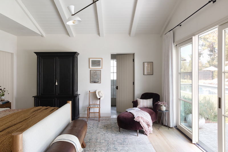 A bedroom in Amber Lewis’s Belgian farmhouse-style home, featuring Marvin Signature Ultimate windows and doors.
