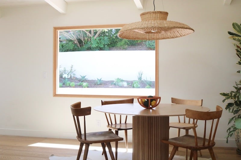 A dining nook next to a Marvin Signature Ultimate picture window.