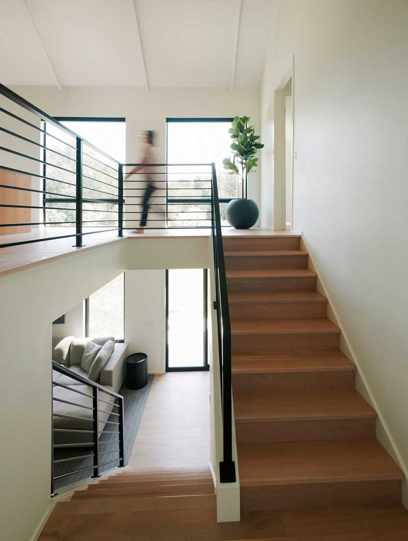 The staircase of a modern home featuring Marvin Essential Direct Glaze windows.