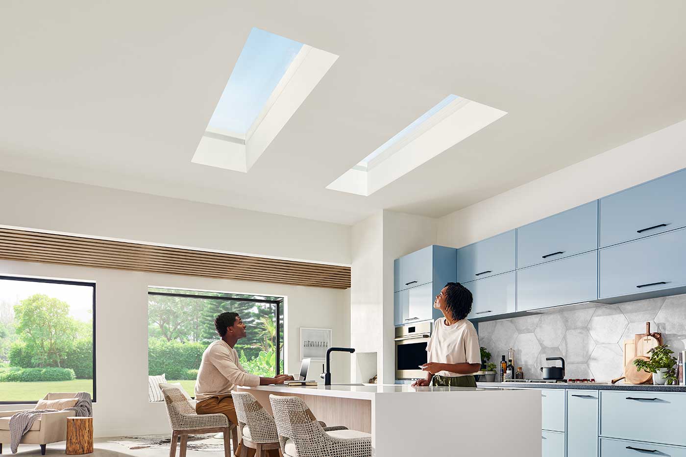 Two people in a kitchen featuring Marvin Awaken Skylights and Marvin Skycove.