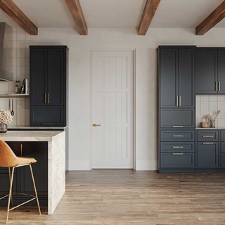 A modern farmhouse kitchen with a white TruStile door, navy cabinetry and white marble countertops.