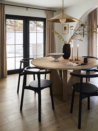 A dining table in the Bobby Berk Firm’s office space featuring a Marvin Ultimate Outswing French door G2.