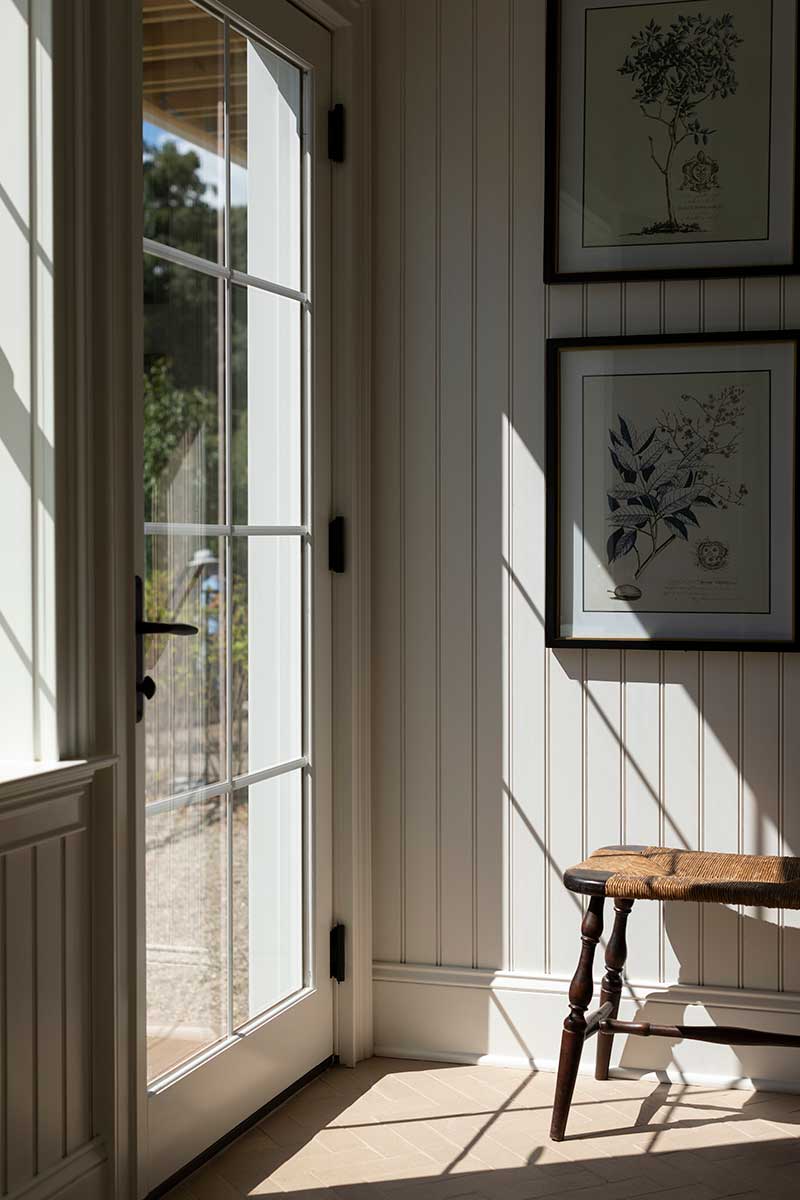 Light streaming into a mud room featuring a Marvin Essential Inswing French door.