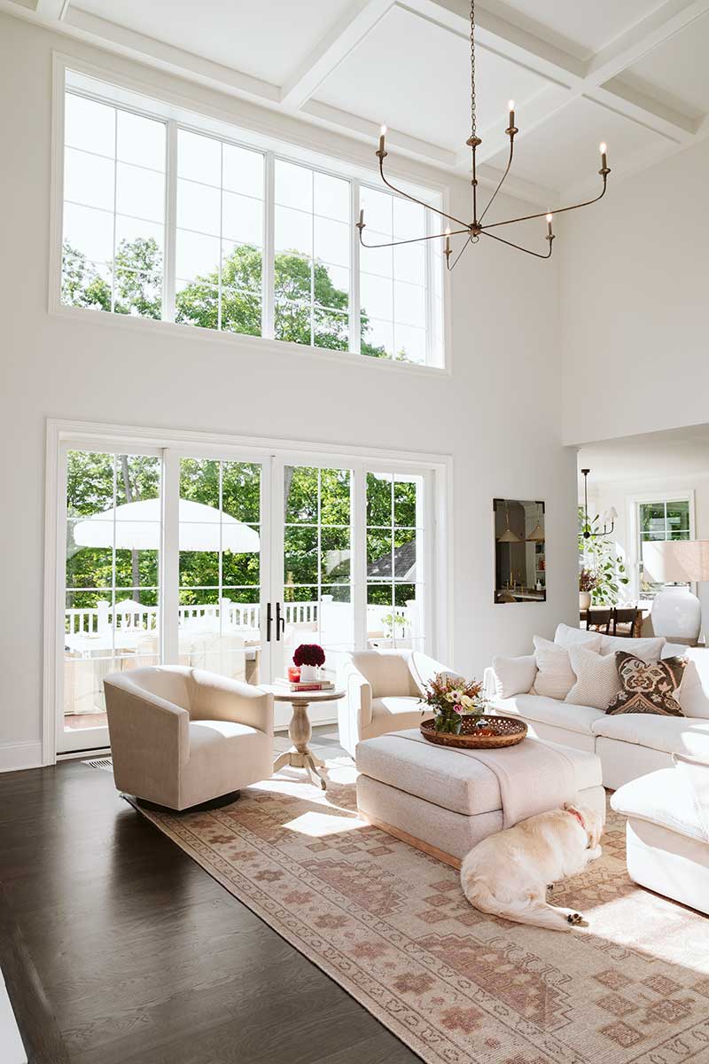 A bright, two-story living room featuring Marvin Essential windows.