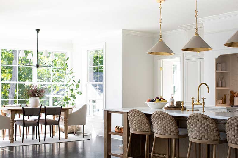 A modern-traditional kitchen and dining room featuring Marvin Essential windows.