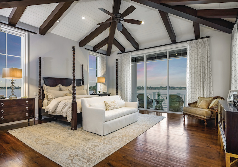 A bedroom featuring Marvin Coastline casement windows and a Marvin Coastline Multi Slide Door on a home in Jupiter, Florida.