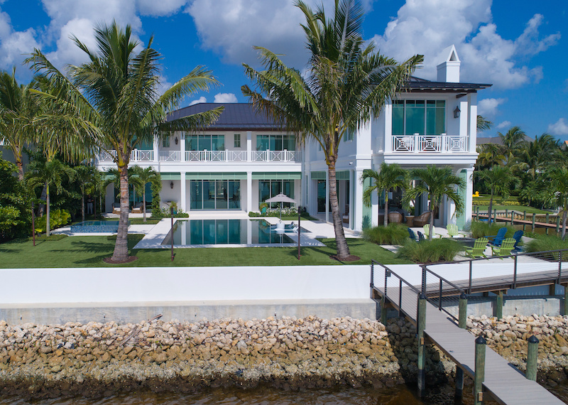 The exterior of a home in Jupiter, Florida, featuring Marvin Coastline Multi Slide Door, Coastline Picture Windows and a Coastline Outswing French Door.