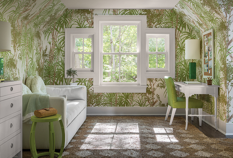 Marvin Ultimate Double Hung windows illuminate a bedroom featuring green plant wallpaper.