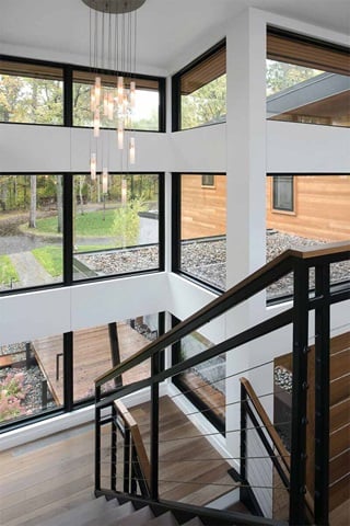 Looking down modern style staircase towards multiple Marvin Windows