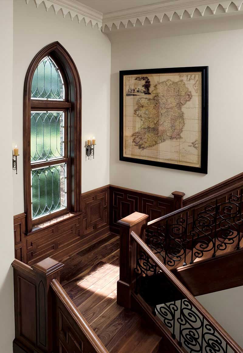 Traditional style staircase looking through historic style Marvin Window