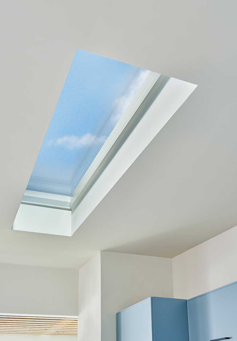 A Marvin Awaken Skylight in a kitchen, with blue sky and clouds beyond.