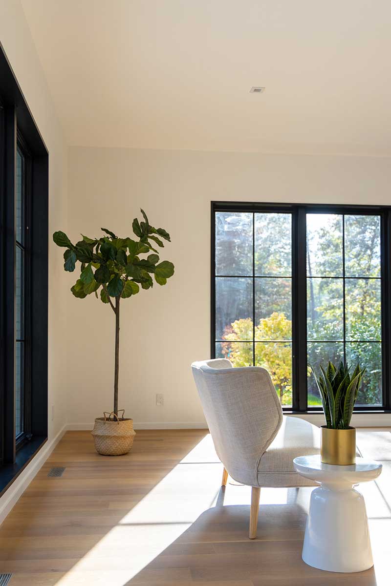 A modern living room featuring black Marvin windows.