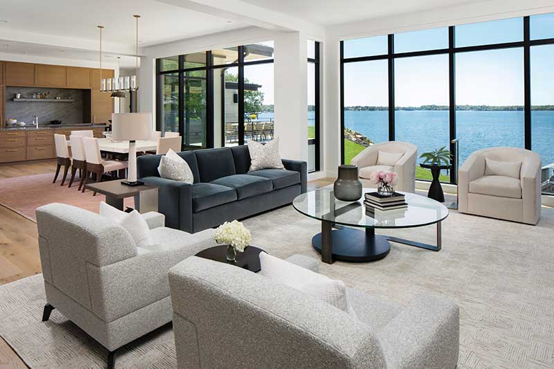 The living room of a modern home on Lake Minnetonka built by John Kraemer and Sons for aging in place, featuring Marvin Modern Direct Glaze and a Modern Multi-Slide Door.  