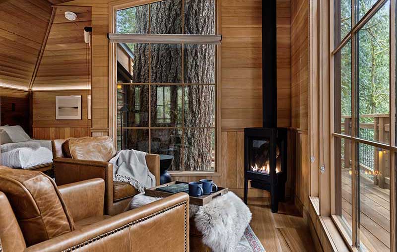 Inside Ananda Treehouse, a bed and breakfast resort in the Pacific Northwest, featuring Marvin Ultimate Casement, Picture and Polygon windows.