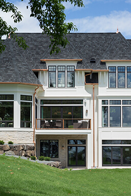 Backyard view of home with large Marvin Windows