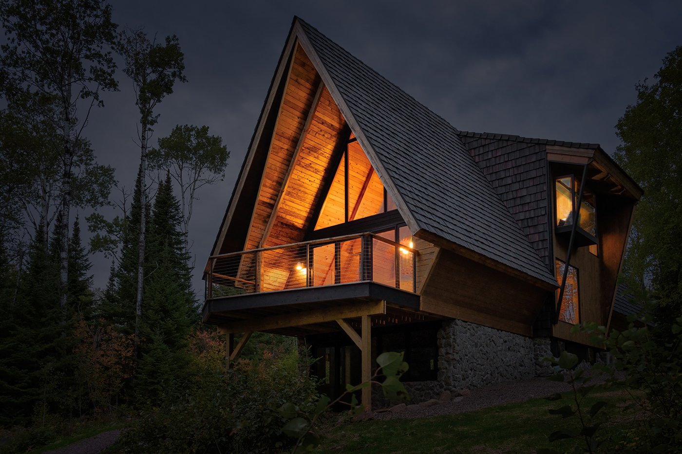 The Minne Stuga A-Frame Cabin at Night, featuring Marvin Ultimate windows and doors, Skycove and Awaken Skylights.