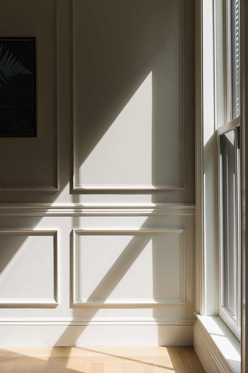 Light from a Marvin Ultimate Double Hung G2 window casting a shadow on a wall in the Hadley House.