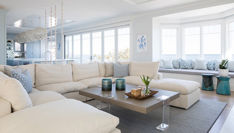The living room, with a large bay of Marvin windows and patio doors, of a home in Fairfield, Connecticut.
