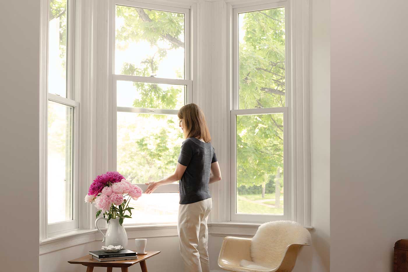 Woman opens a Marvin Ultimate Double Hung window