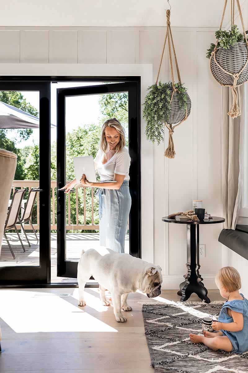 Katie Kurtz in her kitchen with her daughter and bulldog.